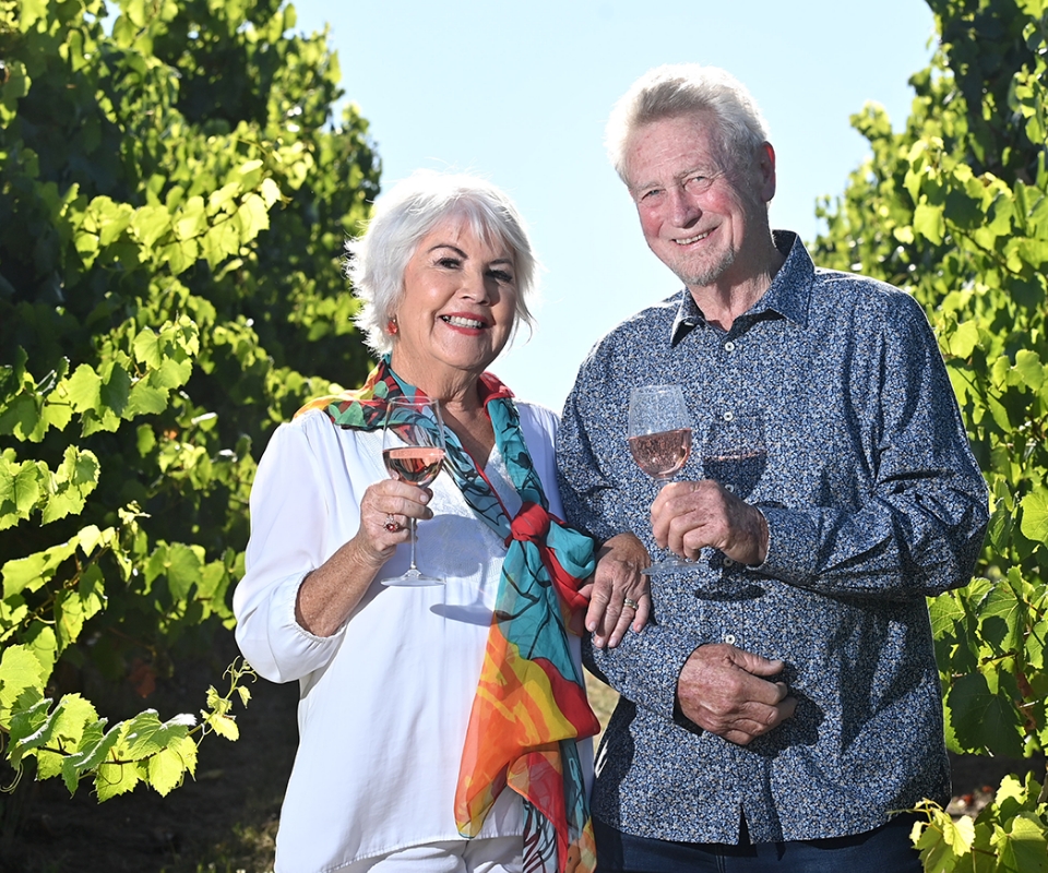 Mike and Judy Press enjoying a glass of wine in their vineyard